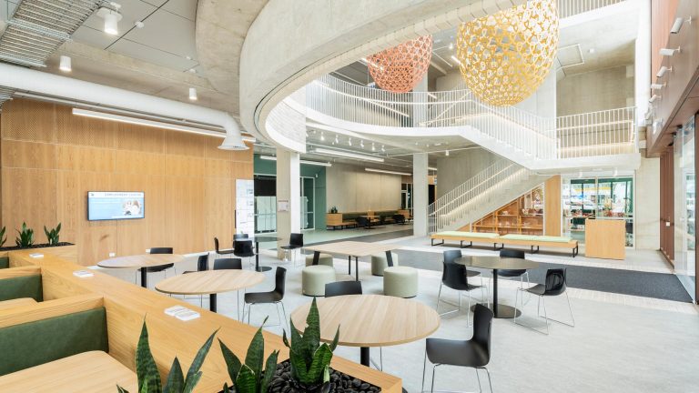 A bright, contemporary interior shot of a building's entrance and communal area