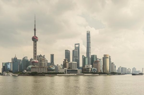 Panoramic view of the Shanghai skyline across the water, showing iconic skyscrapers