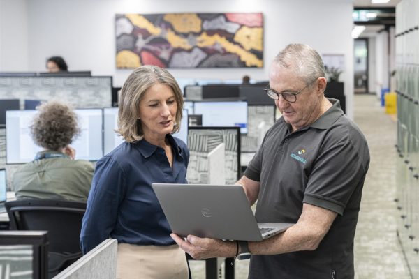 Bendigo Kangan Institute staff conversing over a laptop