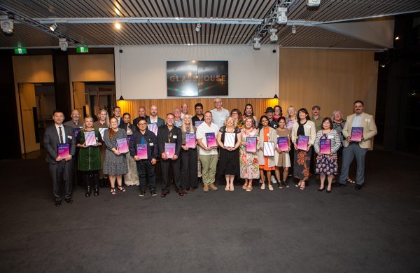 Group image of people holding award certificates